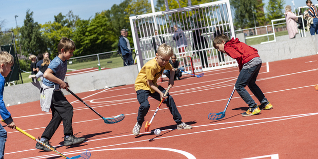 Børn spiller hockey på den nye bane i solskinsvejr. Foto: Frederikssund Kommune, Kenneth Jensen.