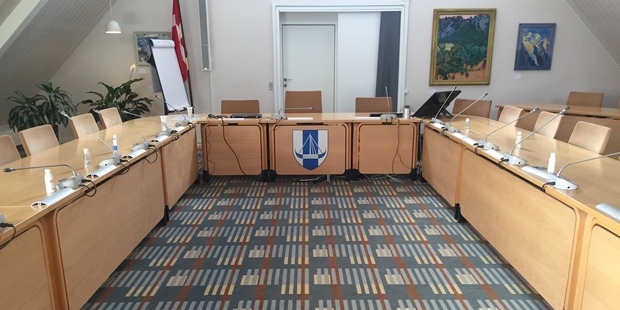 Byrådssalen med Dannebrog i baggrunden. Foto: Frederikssund Kommune.