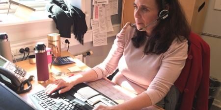 Helene Garly på arbejde i callcenteret med headset foran sin pc. Foto: Frederikssund Kommune. 