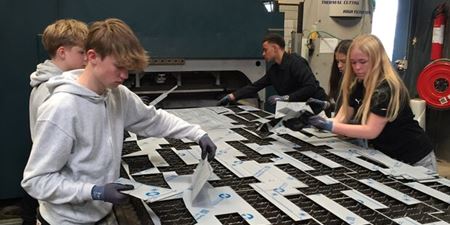 Efter laserskæreren har udført sit arbejde, kan eleverne pille de udskårne emner op fra bordet. Foto: Frederikssund Kommune.